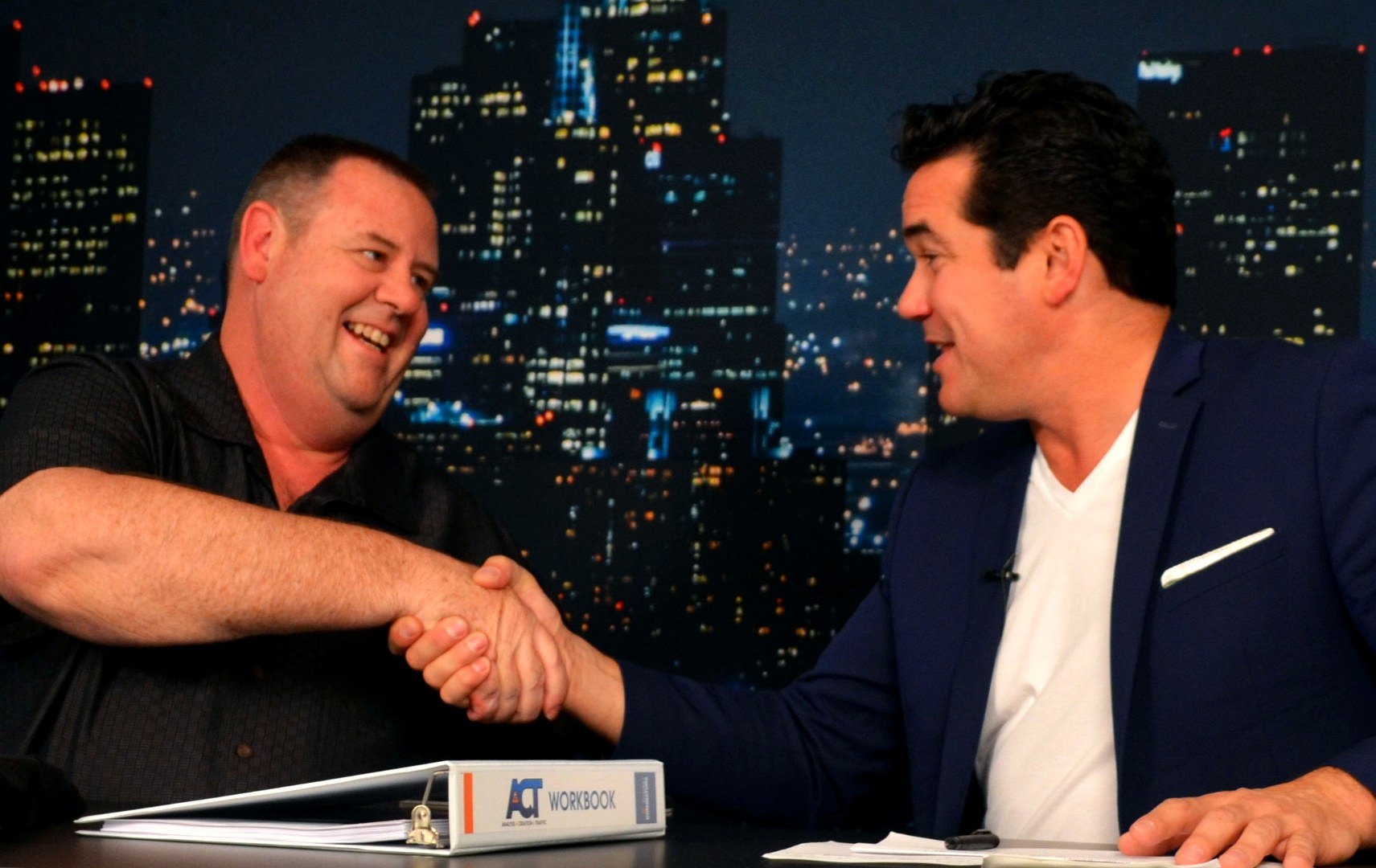 John Limbocker shaking hands with Dean Cain at a media interview