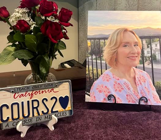 Connie Keyes — in memoriam, photographed at home with roses and a 'Teach Only Love' license plate